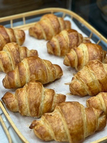Flaky golden croissant rolls in various flavors