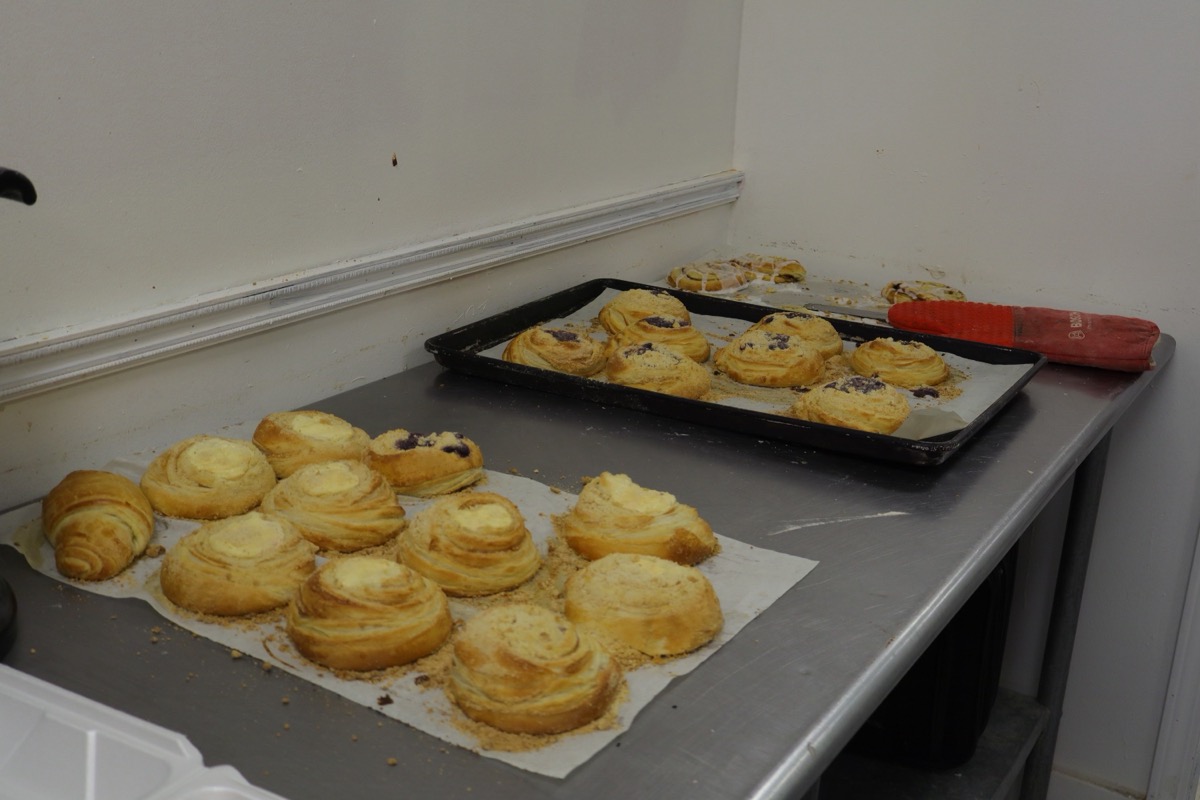 Laminated fruit and sweet cheese danishes cooling on table