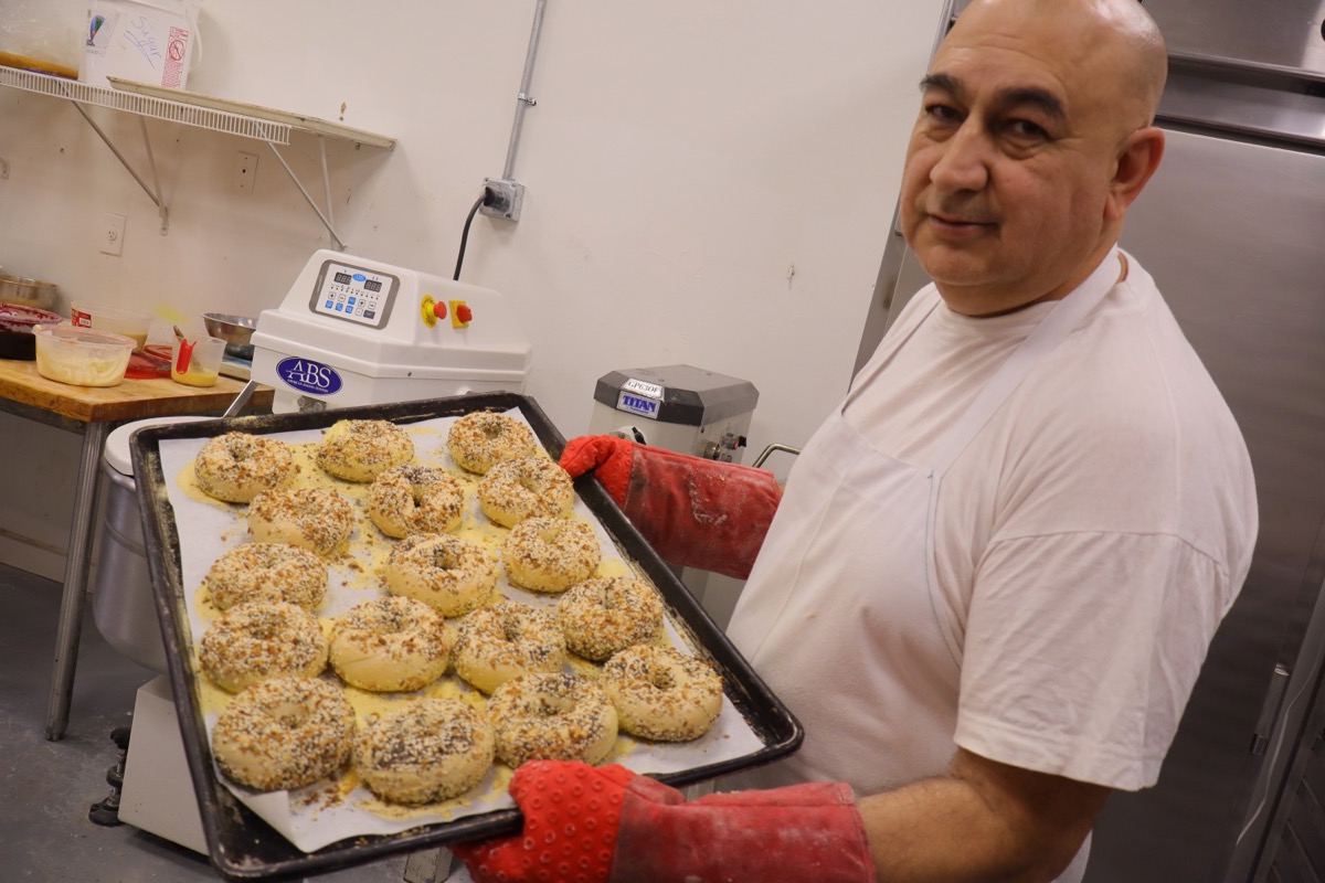 Master Baker Max with tray of fresh artisan bagels