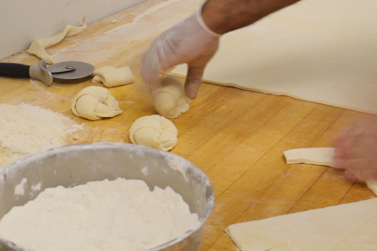 Shaping flaky European butter croissants by hand